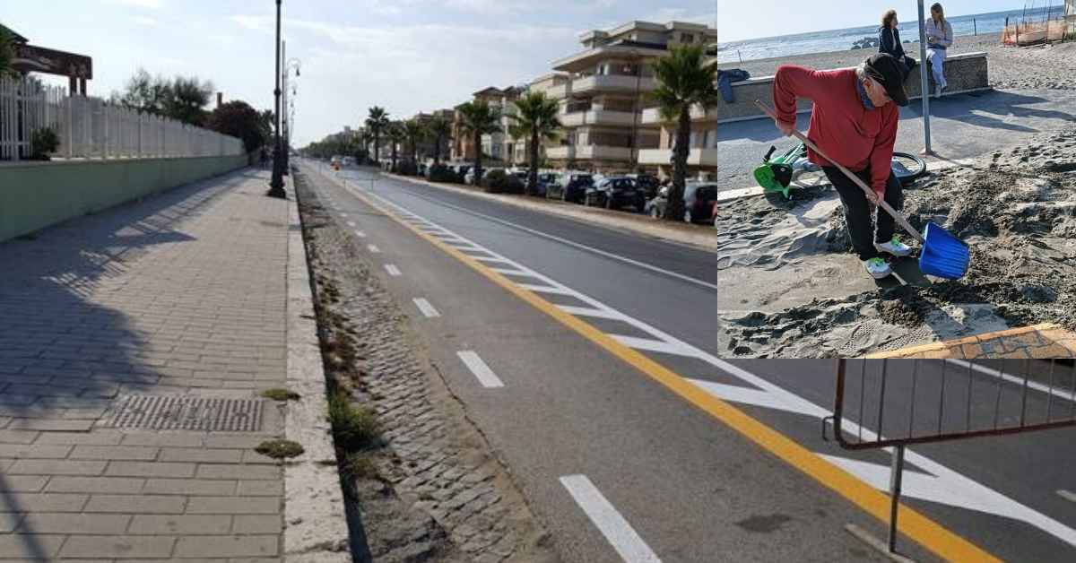 Cittadino spala la sabbia dalla pista ciclabile di Ostia